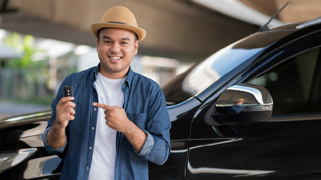 a man pointing at a car key
