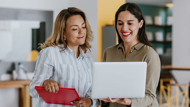 Two women looking at a laptop computer