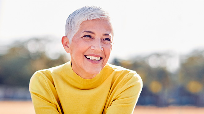 Woman wearing a yellow shirt and smiling