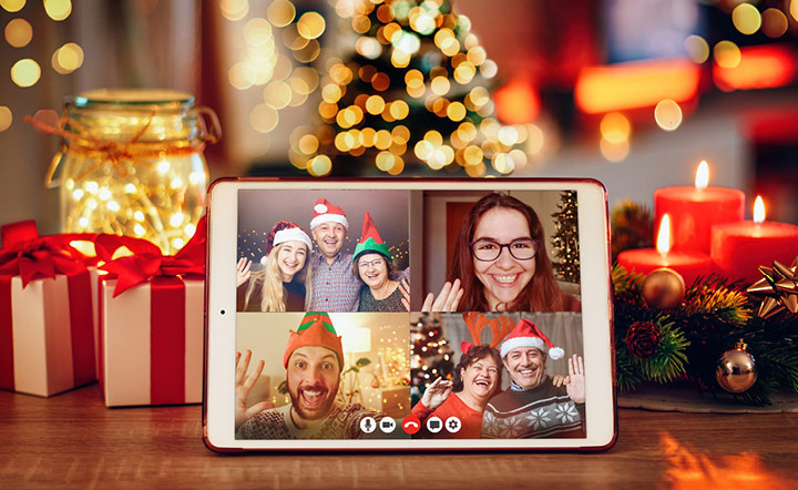 Four people gather on screen for virtual holiday party.
