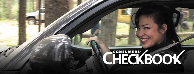A woman happily driving a car. White text says Consumers' Checkbook in the lower right corner.