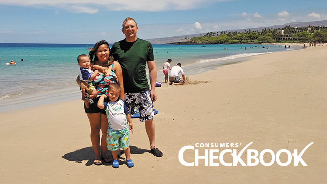 Parents stand smiling with their two young children on a sunny, sandy beach with bright blue water behind them. A logo says Consumers' Checkbook on the lower right.