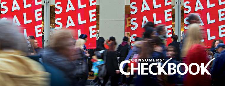 Image shows a bustling crowd with sale signs in the background.