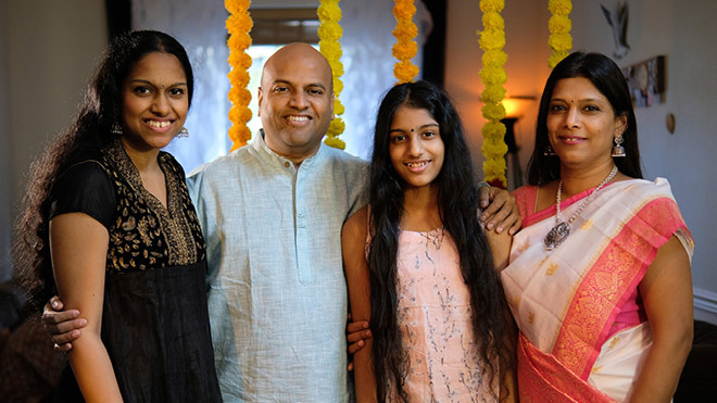 Balaji Ponnuswamy with his daughters, Varsha (left), Priyanka (center right) and his wife, Gayathri (right).