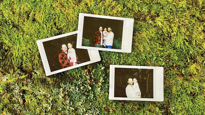 Three Polaroid family photos displayed on a greenery background. The first photo shows one of dads and a daughter, the second shows both fathers and their daughter, and the third shows the other father and daughter. 