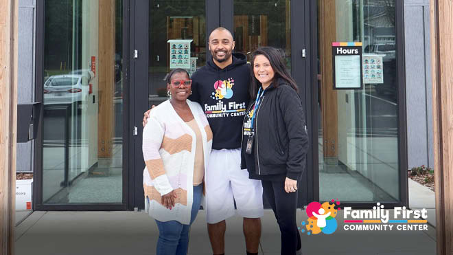 BECU'S Gloria Dixon poses with Doug Baldwin Jr and Jackie Montgomery from the Family First Community Center.