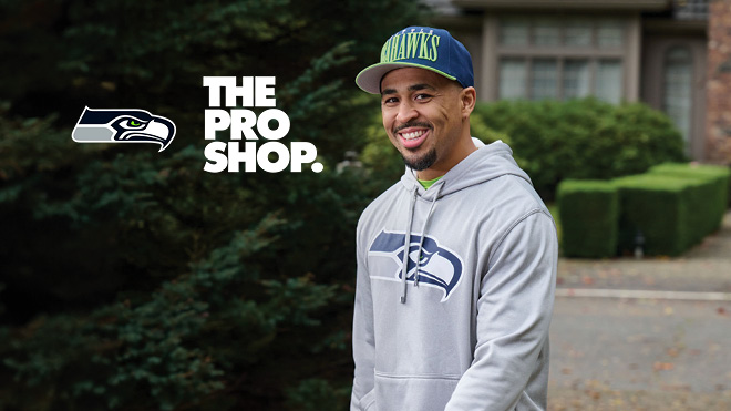 A man in Seattle Seahawks apparel. Seattle Seahawks and the Pro Shop logo.