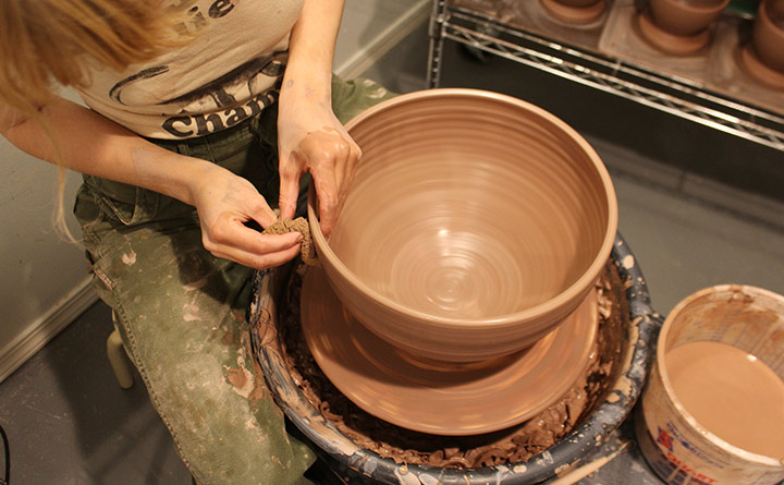 A woman working on a potters wheel